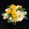 A sunny bouquet filled with the prettiest white and yellow flowers available