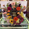 Beautiful arrangement of Hydrangea, Gerbera Daises, Stock, Bells of Ireland, and Sunflowers.