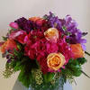 Bright, colorful arrangement with oranges, purples and hot pinks in a square