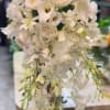 A vision of pure elegance, this all-white bridal bouquet captures the essence