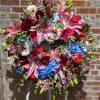 Large classic wreath designed in tranquil colors; including pinks, blues and whites