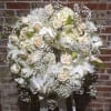 A beautiful floral tribute for the deceased. A lush palette of white