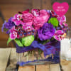 Beautiful jewel tone flowers in a small glass vase.