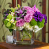 This modern bundle is the perfect chic adornment. Lavender roses, cabbage, green