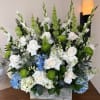 Asortment of white and blue flowers, like hydrangeas, roses, gladiolas, and stock.
Some