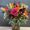 Standing in a tall vase with accented river rocks you&#039;ll find varied