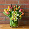 20 multicolor tulips with 2 green orchids accented with bear grass.
Colors may