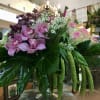 This arrangement is something special. It consists of dark pink orchids, esperance