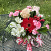 Indulge in our Strawberry Sundae floral arrangement, featuring vibrant red blooms and