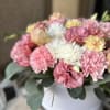 Like a gentle cloud touched by morning light, this arrangement enchants with