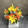 Alstroemeria, lilies and roses in bright happy yellows and orange with eucalyptus.
