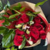 A lovely hand-tied bouquet with a dozen red roses, and light pink