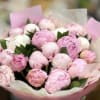 A luxurious bouquet of 25 fresh peonies in soft shades of blush