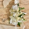 Made from fresh flowers, a corsage looks like a petite flower arrangement