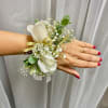 Made from fresh flowers, a corsage looks like a petite flower arrangement