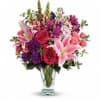 Hand-delivered in a shapely glass vase, this sumptuous arrangement of roses and