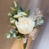 Made from fresh flowers, a boutonniere looks like a petite flower arrangement