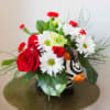 An adorable ceramic animal, filled to bursting with bright blooms including roses