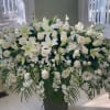 This casket spray with heavenly white flowers is perfect for a gracious
