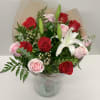 A beautiful bouquet whit red roses, pink roses, white lili,eucalyptus and wax
