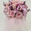 This stunning floral arrangement is a true showstopper, featuring pink roses and