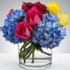 A cute showstopper. Bright multicolored roses make this darling arrangement pop. Perfect
