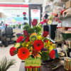 We make a beautiful large birthday arrangement with orchids and roses and
