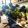 We take 12 blue roses and arrange them in a vase with
