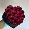 Dark, fuchsia preserved roses, placed in a velvet black heart shaped box