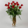 This romantic arrangement features our premium red roses with lush greens in