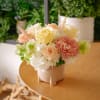 This flower arrangement showcases a soft and warm palette of ivory and