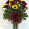 Beautiful long stem red roses beautifully designed with splashes of bursting sunflowers