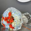 This bouquet features radiant orange roses symbolizing enthusiasm and warmth, nestled among