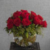 Sixteen gorgeous roses arranged in a clear globe vase with assorted greenery.