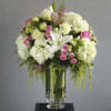 A beautiful, garden style arrangement with premium flowers. White lilies, pink roses