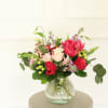 Blooming Delight is a charming mix of pink roses, tulips, and hypericum