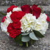 This arrangement has roses, hydrangeas, carnations, mini carnations and eucalyptus in a