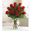 One dozen red roses in a clear vase with greenery. Great for