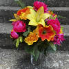 This arrangement is made with all silk flowers. The vase is not