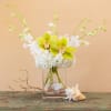 A gorgeous, contemporary beach side arrangement of tropical white dendrobium and green