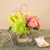 A sweet arrangement of roses, tulips and spider mums arranged in a