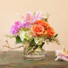 A sweet semi-compact arrangement of roses, stargazer oriental lilies, hydrangea and other