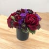 Purple Lysianthus and Amaryllis with greenery.