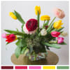 A glorious little arrangement of Gerbera daisies and tulips, gathered in a