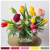 A glorious little arrangement of Gerbera daisies and tulips, gathered in a