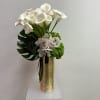 A striking statement piece, this modern arrangement features elegant white calla lilies