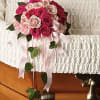 The delicate bouquet includes hot pink spray roses and light pink miniature