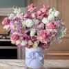 Indulge in the beauty of this exquisite pink and white floral arrangement