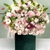 A romantic blend of pale pink roses, orchids, lisianthus, and ranunculus, this