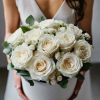 The combination of delicate white roses and greenery creates a unique masterpiece